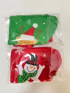 Detail of red snowman and green reindeer Christmas stockings in clear packaging