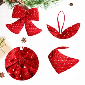 Detail of red Christmas bow with golden embroidery, sequins and pine cone decor