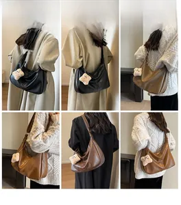 Detail view of large shoulder bags with plush bear charms in black, khaki, and brown