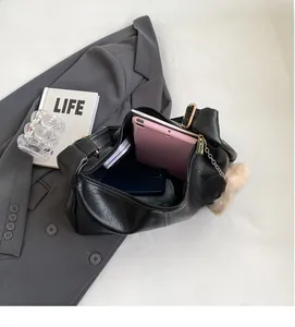 Interior view of black lychee leather hobo bag holding a tablet and daily essentials