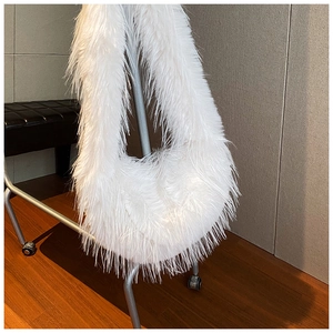 Gros plan sur le sac à bandoulière blanc en fausse fourrure douce avec design en lune