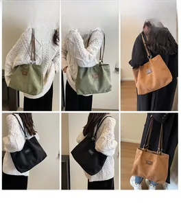Detail view of large matte tote bags with heart embossing in green, brown and black colors
