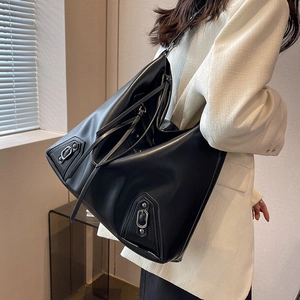 Oversized black leather motorcycle tote bag with silver studs and long tassels