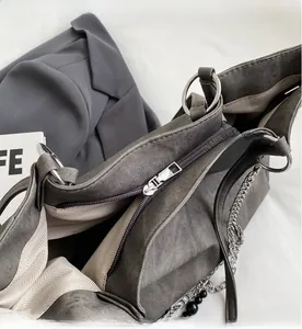 Detail of smooth metal zipper and grey herringbone fabric lining inside the tote bag