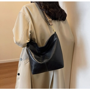 Black tote bag shown from behind featuring wide bohemian jacquard shoulder strap detail