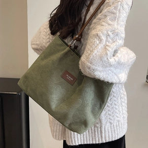 Forest green tote bag with heart embossing and brown leather straps for autumn style