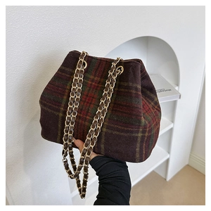 Détail du sac à bandoulière en laine à carreaux avec chaîne en cuir et style rétro anglais