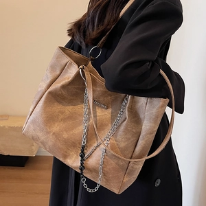 Large brown vintage tote bag with metal chain detail and dual shoulder straps