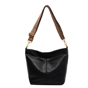 Retro black leather bucket bag with bohemian woven wide strap and gold hardware accents