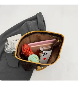 Overhead view showing large interior capacity of vintage monogram tote with daily items