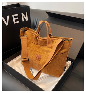 Detail of ginger yellow corduroy tote bag with adjustable strap and leather patch