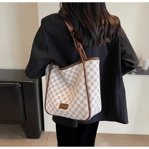 Back view of a large red and white checkerboard tote bag worn over the shoulder