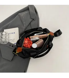 Interior view of black nylon tote bag showing spacious capacity for phone and umbrella