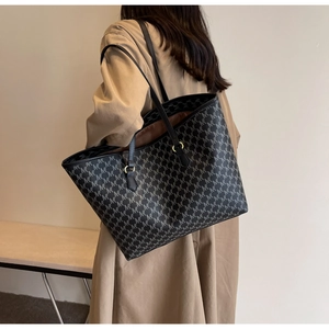Large tote bag with M-letter pattern on khaki trench coat model for commute
