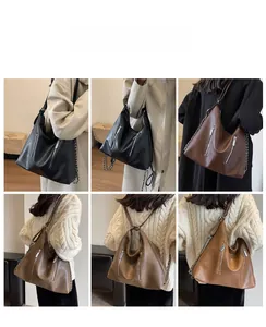 Detail of multi-color large leather tote bag with vertical zippers and chain strap