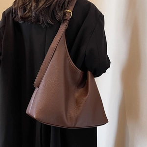 Deep brown lychee pattern tote bag with wide adjustable strap and gold metal buckles