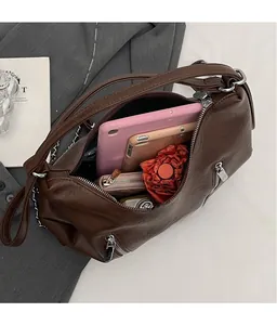 Detail view of large brown backpack interior showing spacious storage and luxury texture