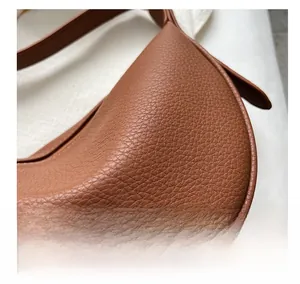 Close-up of brown litchi pattern leather texture with gold Fashion lettering