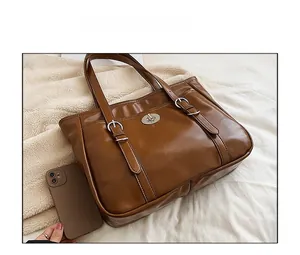 Brown vintage tote bag size comparison with a smartphone showing large capacity