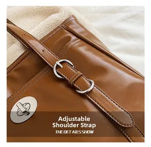 Close-up of adjustable brown leather strap with silver buckle and metal swivel lock detail