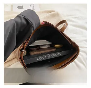 Internal view showing the large capacity and multiple compartments of this brown tote bag