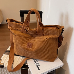 Brown corduroy tote bag with adjustable strap and side pockets for casual daily use