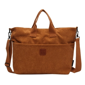 Brown corduroy tote bag with front pocket and adjustable shoulder strap for women
