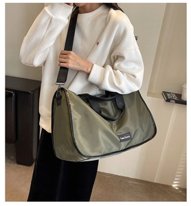 Army green nylon tote bag shown on model with black shoulder straps for commute