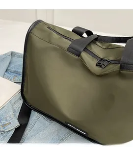 Detailed close-up of an olive green large travel bag featuring durable nylon and dual zippers