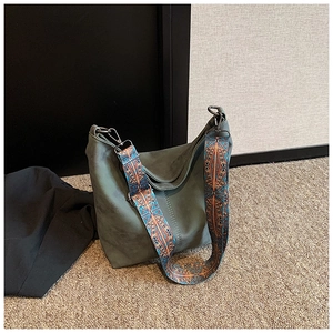 Detail of hobo bag featuring retro matte texture and ethnic style printed wide shoulder strap