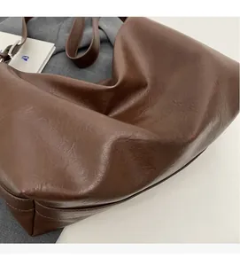 Macro view of the soft brown texture and matte surface of this large commuter tote bag