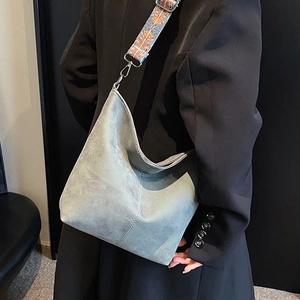 Retro grey-green large Hobo bag with bohemian patterned wide strap shown on a model