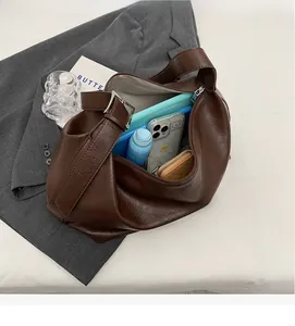 Interior view of spacious dark brown hobo bag showing large storage for daily essentials