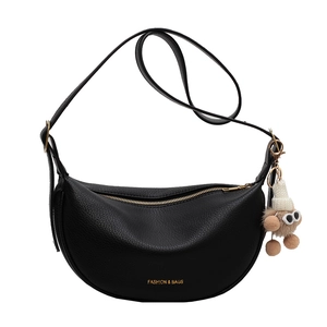 Black crescent dumpling bag with lychee grain leather and a cute plush bear pendant