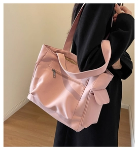 Detail of pink canvas tote bag with multi-pocket structure for commuting and daily use