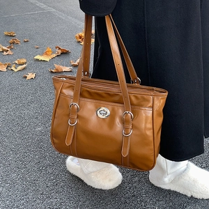 Brown vintage faux leather tote bag with silver turn-lock and adjustable straps