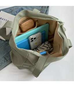 Top view of spacious interior compartments and woven texture of the sage green tote bag