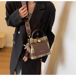 Retro plaid wool bucket bag with leather accents and wide strap for autumn winter fashion