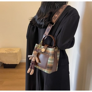 Chic vintage plaid bucket bag with wide jacquard strap and cute plush rabbit charm