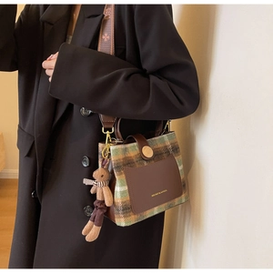 Plaid wool crossbody bucket bag with leather trim and brown plush bear charm