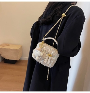 Detail of tweed crossbody bag with sequins, pearl luster and cute plush charm pendant