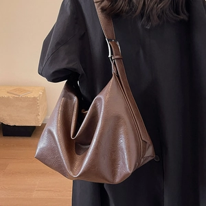 Large brown leather hobo bag with vintage texture and adjustable wide shoulder strap