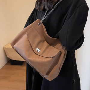 Brown large capacity leather tote bag with silver chain strap and metal turn-lock closure
