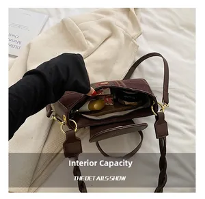 Top view of large capacity interior showing daily items inside brown plaid handbag