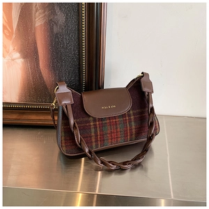 Close-up of retro plaid underarm bag with braided leather strap and gold logo detail