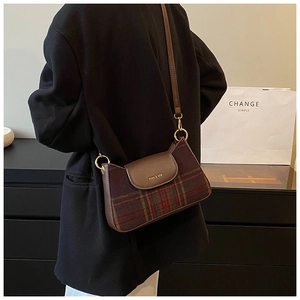 Detail of miao & sha logo on vintage plaid wool and brown leather underarm bag