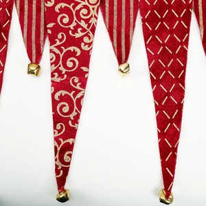 Red velvet Christmas table runner with gold glitter patterns and small metal bells