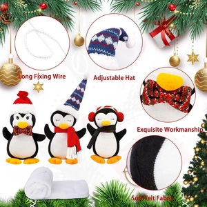 Detail of plush Christmas penguins showing soft felt fabric and long fixing wire
