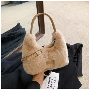 Detail of plush khaki faux fur bag showing soft texture and adjustable leather strap