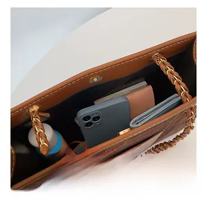 Detail showing the spacious interior of the color-block tote bag with a magnetic buckle